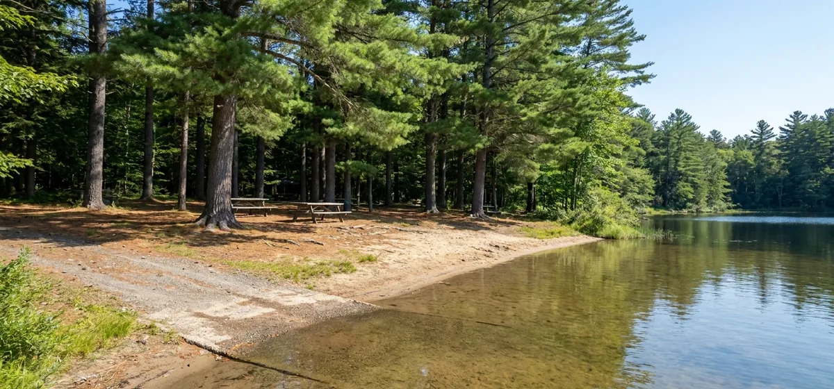 Sand beach and calm water at Buck Pond near Rainbow Lake, New York