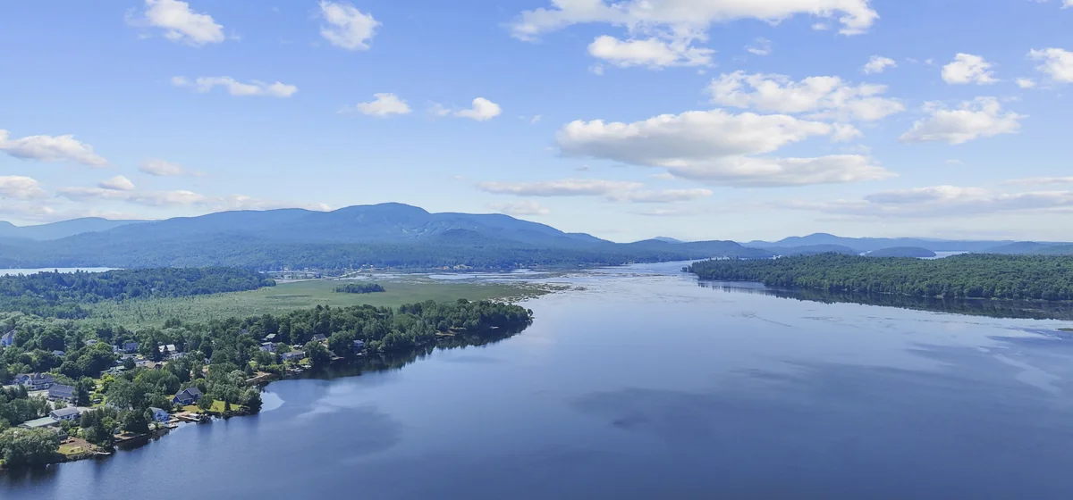 Raquette Pond and wooded shoreline in Tupper Lake, New York